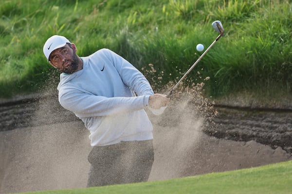 Scottie Scheffler of the United States plays out of a bunker on the 11th hole during a practice round for the British Open golf championship at the Royal Portrush Golf Club, Northern Ireland, Wednesday, July 16, 2025. (AP Photo/Peter Morrison)