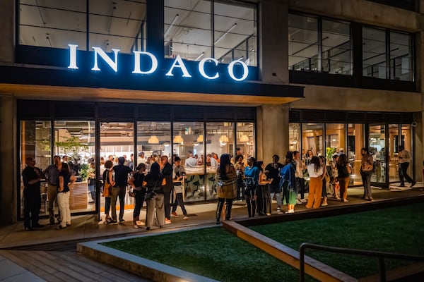 The outside of Indaco at night, showing a crowd of well-dressed would-be patrons waiting to enter.