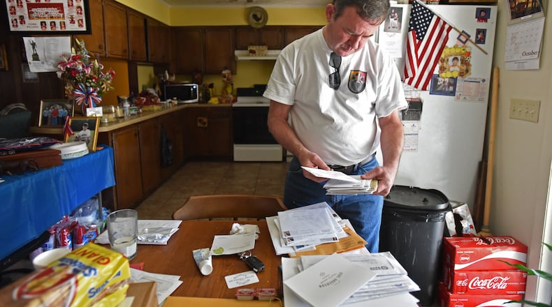 Ardie Wright glances at a stack of sympathy cards. He hasn’t had time to open them yet. People from across the country – neighbors, friends, even strangers – are writing to offer their condolences about the death of his son, Staff Sgt. Dustin Wright. “He was like John Wayne, OK?” Ardie said of his son. “When he walked through the door with his sparkling blue eyes – and his smile – he just lit the room up." HYOSUB SHIN / HSHIN@AJC.COM