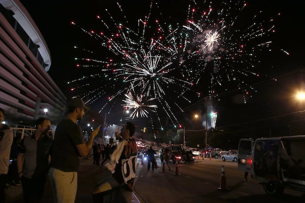 January 14, 2017, Atlanta - Fans light and launch fireworks following the Atlanta Falcons win over the Seattle Seahawks in Atlanta, Georgia, on Saturday, January 14, 2017. The same occasion marks the last night the Georgia Dome will see use, after which it will be replaced by the Mercedes Benz Stadium.(HENRY TAYLOR / HENRY.TAYLOR@AJC.COM)