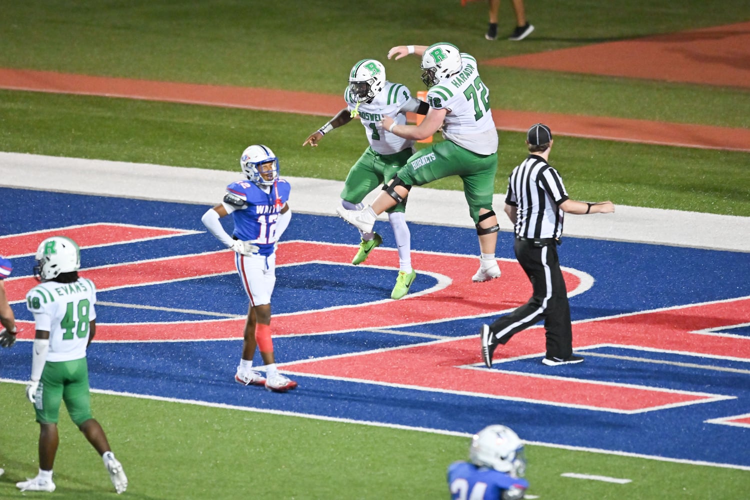 Roswell quarter back Trey Smith (1) celebrates with offensive lineman Jake Harmon (73) after Smith ran a 39-yard touchdown against Walton during the first half of a game Friday, August 29, 2025 at Walton High School. (Daniel Varnado/For the Atlanta Journal-Constitution)