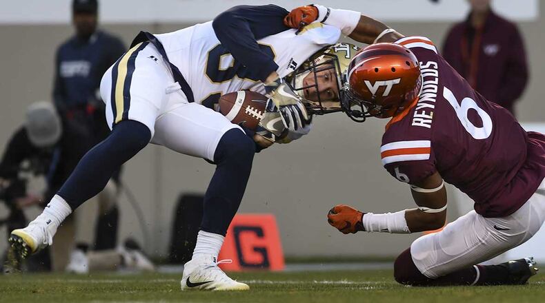 Georgia Tech's Brad Stewart is hit during his punt return by Virginia Tech's Mook Reynolds.