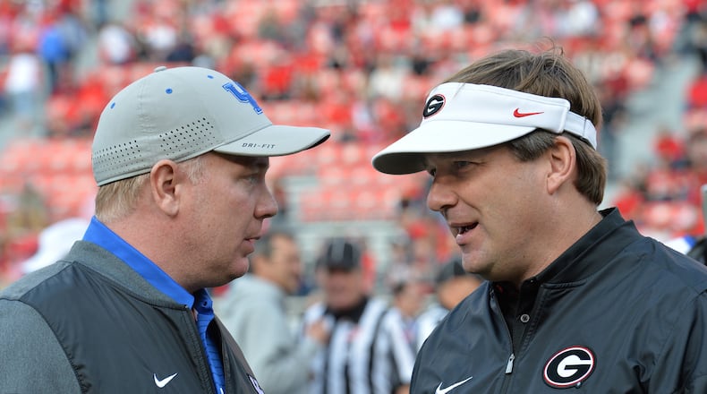 Georgia head coach Kirby Smart, right, and Kentucky head coach Mark Stoops talk before the start of a game on Nov. 18, 2017, in Athens, Ga. (Hyosub Shin/Atlanta Journal-Constitution/TNS)