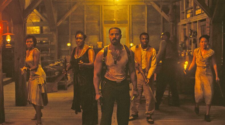 This image released by Warner Bros Pictures shows Michael B. Jordan, center, in a scene from "Sinners." (Warner Bros. Pictures via AP)