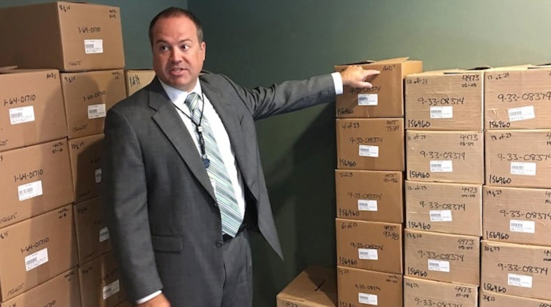 Neil Troppman, a manager of ATF's tracing center, stands next to boxes of firearms records that recently arrived at the agency's facility in West Virginia. (Del Quentin Wilber/Los Angeles Times/TNS)