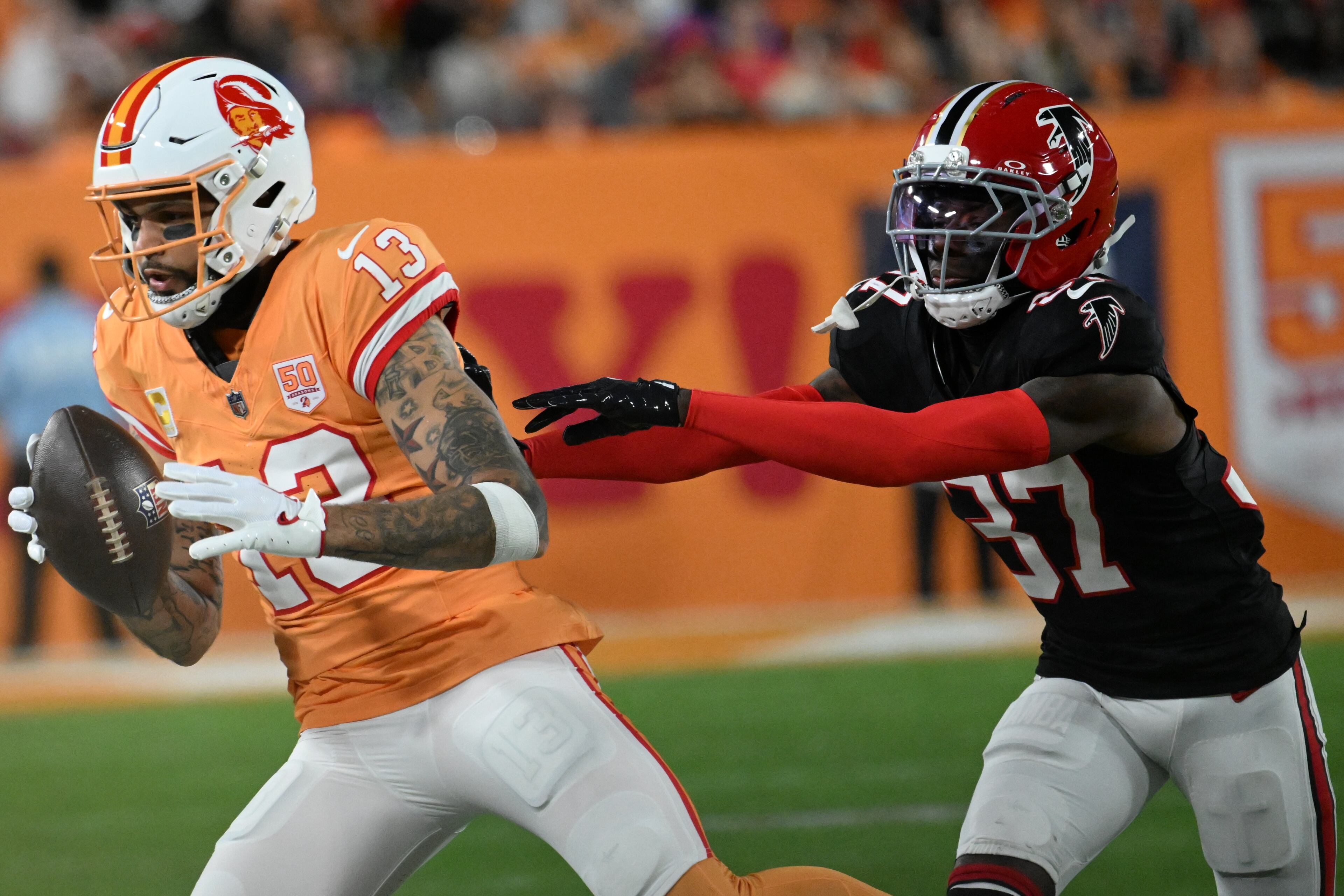 Tampa Bay Buccaneers wide receiver Mike Evans (13) runs against Atlanta Falcons cornerback Cobee Bryant (37) during the first half of an NFL football game, Thursday, Dec. 11, 2025, in Tampa, Fla. (AP Photo/Jason Behnken)