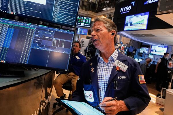 Trader Robert Charmak works on the floor of the New York Stock Exchange, Friday, July 18, 2025. (AP Photo/Richard Drew)