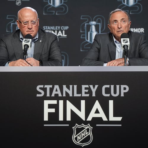 NHL commissioner Gary Bettman, right, speaks as deputy commissioner Bill Daly listens during a news conference ahead of Game 1 of the NHL hockey Stanley Cup final series between the Edmonton Oilers and Florida Panthers in Edmonton, Alberta, Wednesday, June 4, 2025. (Darryl Dyck/The Canadian Press via AP)