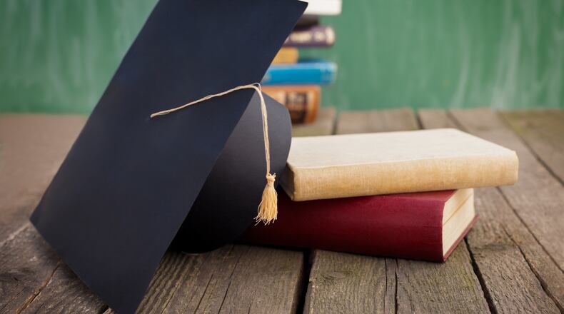 Books and graduation cap on table (stock photo)