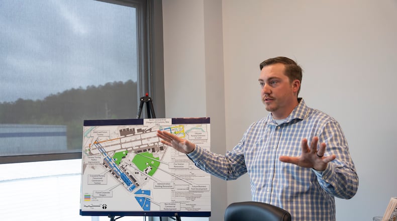 Jonathan Gauthier shows development plans on a map at the Fulton Executive Airport as part of a larger investment plan to renew Fulton Industrial Blvd in Atlanta, Georgia on Thursday, April 11, 2024. (Olivia Bowdoin for the AJC).