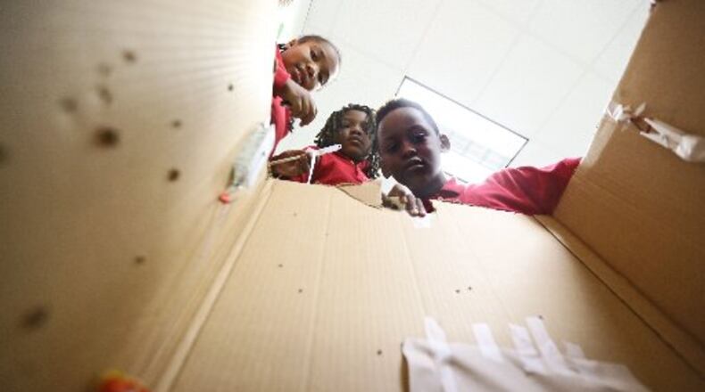 Students at McNair Discovery Learning Academy built traps to catch an endangered frog earlier this year (AJC FILE PHOTO)