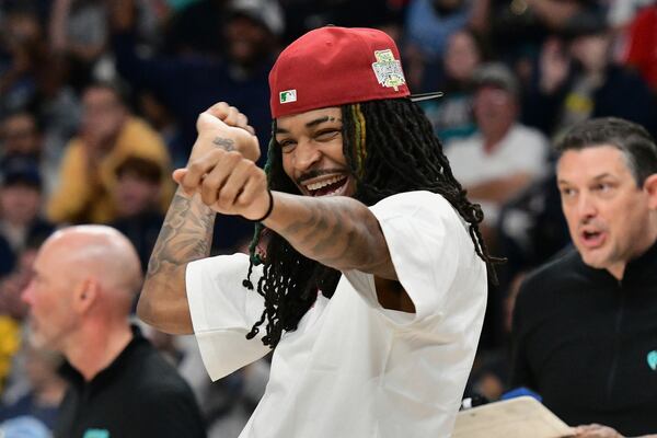 Memphis Grizzlies guard Ja Morant (12) reacts from the sideline in the first half of an NBA basketball game against the Dallas Mavericks Sunday, April 13, 2025, in Memphis, Tenn. (AP Photo/Brandon Dill)