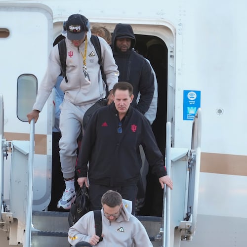 Indiana head coach Curt Cignetti, walks off the plane after the team arrived at the Indianapolis International Airport in Indianapolis, Tuesday, Jan. 20, 2026. (AP Photo/Michael Conroy)