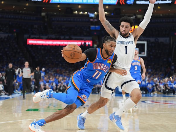 Oklahoma City Thunder guard Isaiah Joe (11) drives past Memphis Grizzlies guard Scotty Pippen Jr. (1) during the first half in Game 1 of an NBA first-round playoff series, Tuesday, April 22, 2025, in Oklahoma City. (AP Photo/Kyle Phillips)