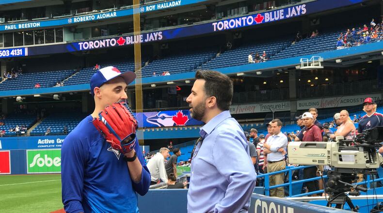 Braves general manager Alex Anthopoulos, who once held that post with the Blue Jays, catches up with Toronto pitcher Aaron Sanchez before Wednesday’s game at Rogers Centre. (Photo by David O’Brien/AJC)