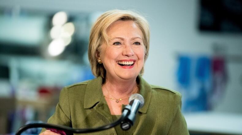 Democratic presidential candidate Hillary Clinton holds a tie made byKnotty Tie as she speaks after taking a tour of the Knotty Tie Company in Denver, Wednesday, Aug. 3, 2016. The Knotty Tie Company makes and manufactures ties and scarves by hand in Denver. (AP Photo/Andrew Harnik)