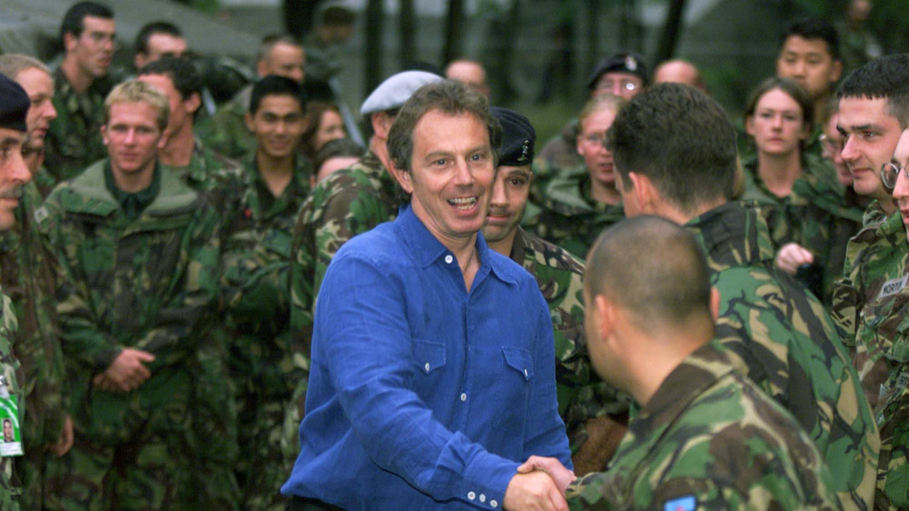 FILE - British Prime Minister Tony Blair, greets British KFOR troops at the KFOR headquarters in Pristina after his arrival here late Friday evening July 30, 1999. (AP Photo/David Brauchli, File)