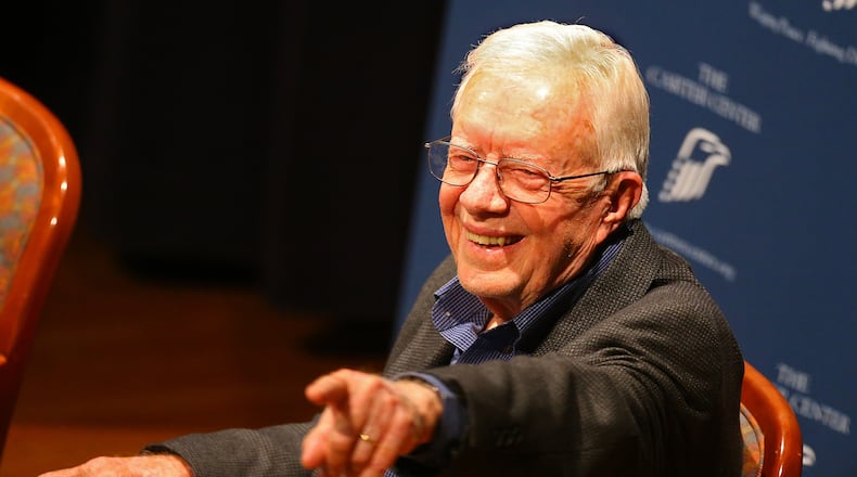 President Jimmy Carter points out a member of the audience during "Conversations at the Carter Center" discussing the centers ongoing and latest efforts around the world on Tuesday, Sept. 16, 2014, in Atlanta. CURTIS COMPTON / CCOMPTON@AJC.COM Former President Jimmy Carter. AJC file/Curtis Compton