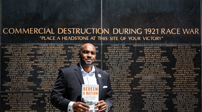 Damario Solomon-Simmons poses for a portrait at the memorial for the 1921 Tulsa Race Massacre on Saturday, May 2, 2026, in Tulsa, Okla. Solomon-Simmons is the author of a new book about reparations over the Tulsa Race Massacre (AP Photo/Milo Gladstein)