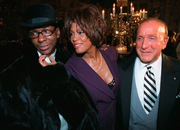 Bobby Brown, left, and Whitney Houston appear with music producer Clive Davis, right, at a pre-Grammy party in New York on Feb. 24, 1998. (Stuart Ramson/AP)