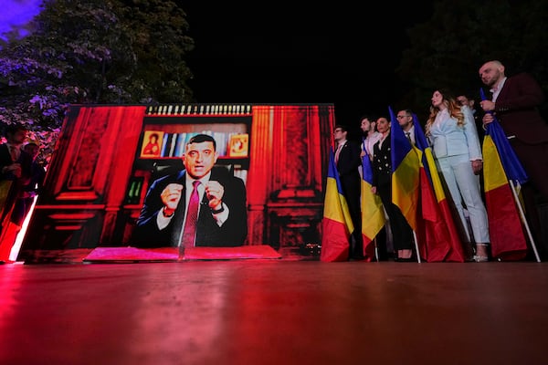 Presidential candidate George Simion addresses supporters via video link after polls closed for the first round of the country's presidential election redo in Bucharest, Romania, Sunday, May 4, 2025. (AP Photo/Andreea Alexandru)