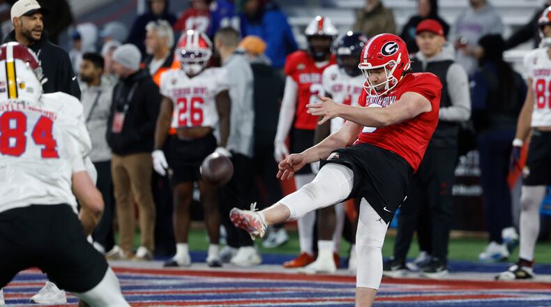 American team punter Brett Thorson (right) runs through drills during practice for the Senior Bowl on Tuesday, Jan. 27, 2026, in Mobile, Ala. Thorson is a former Georgia standout. (Butch Dill/AP)