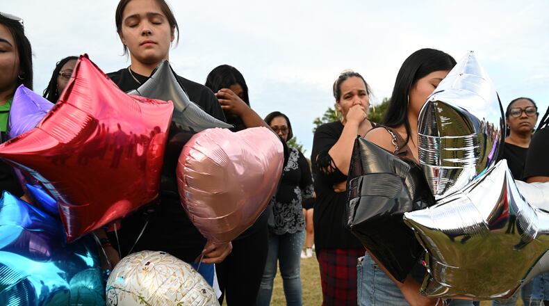 Community members gathered at Jug Tavern Park on Wednesday, September 4, 2024, to mourn victims of a mass shooting at Apalachee High School. (Hyosub Shin / AJC)