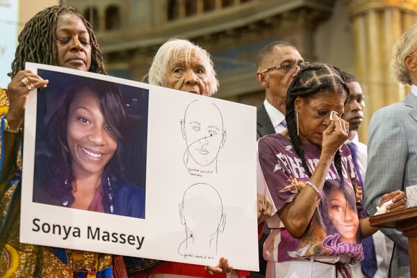 FILE - Donna Massey, center right, wipes tears from her face as she listens to Rev. Al Sharpton, right, speak during a press conference Tuesday, July 30, 2024, in Chicago, over the shooting death of her daughter Sonya, who was allegedly killed by Illinois sheriff's deputy Sean Grayson. (Tyler Pasciak LaRiviere/Chicago Sun-Times via AP)