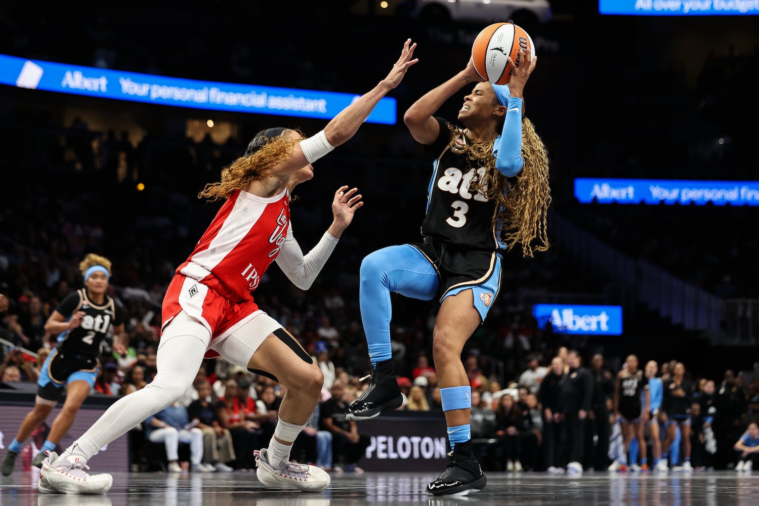 Dream guard Jordin Canada (right) shoots against Aces guard Chennedy Carter on Sunday, May 17, 2026, at State Farm Arena in Atlanta. (Colin Hubbard for the AJC) 

