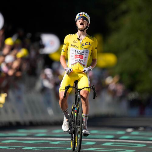 Slovenia's Tadej Pogacar, wearing the overall leader's yellow jersey, celebrates after winning the tenth stage of the Tour de France cycling race with start in Aurillac and finish in Le Lioran, France, Tuesday, July 14, 2026. (AP Photo/Mosa'ab Elshamy)