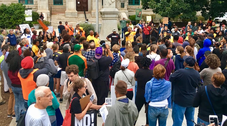 Protesters gather before Decatur’s 109-year-old Confederate monument during a September march. That monument is getting closer to removal from the city’s square and probably to the nearby cemetery. Bill Banks for the AJC