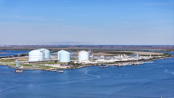 An aerial image shows Southern LNG Company’s liquefied natural gas tanks visible above the Savannah River. (Miguel Martinez/AJC)