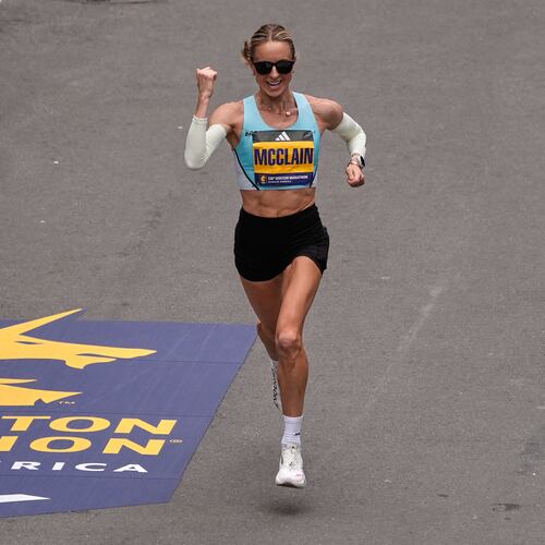 Jess McClain of Phoenix, the top American woman finisher, pumps her fist while approaching the finish line of the Boston Marathon, Monday, April 20, 2026, in Boston. (AP Photo/Charles Krupa)