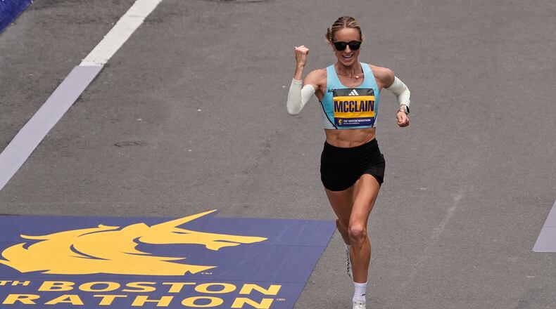 Jess McClain of Phoenix, the top American woman finisher, pumps her fist while approaching the finish line of the Boston Marathon, Monday, April 20, 2026, in Boston. (AP Photo/Charles Krupa)