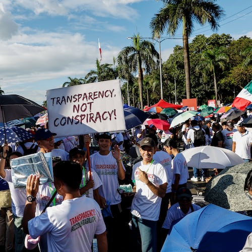 Members of the religious sect Iglesia Ni Cristo (Church of Christ) hold a placard as they participate in a three-day anti-corruption rally at Manila's Rizal Park, Philippines, Sunday, Nov. 16, 2025. (AP Photo/Mark Cristino)