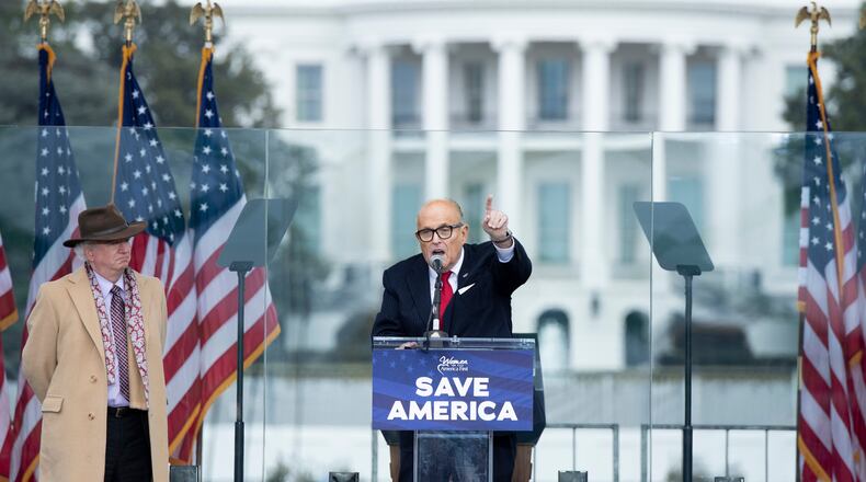 Rudy Giuliani speaks to supporters from The Ellipse near the White House on Jan. 6, 2021, in Washington, D.C. Standing by and watching is lawyer John Eastman. (Brendan Smialowski/AFP/Getty Images/TNS)