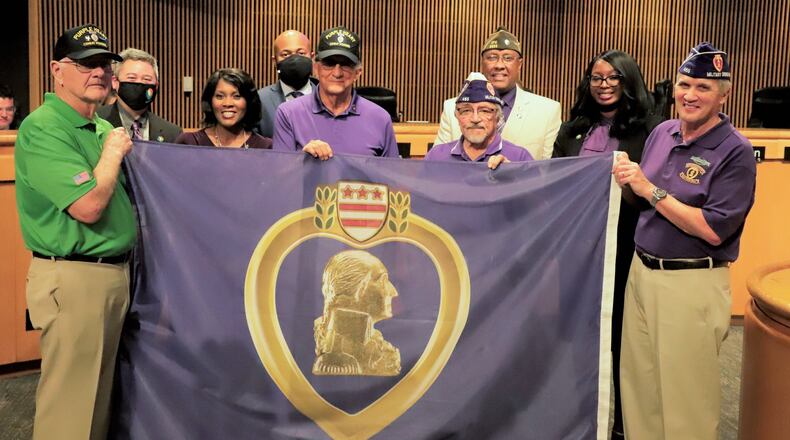 Gwinnett Commissioners on July 27, 2021 presented a proclamation to Lou Zayas, commander of Chapter 465 of the Military Order of the Purple Heart. Zayas was accompanied by veterans with the American Legion, Veterans of Foreign Wars and volunteers from the Gwinnett County Veterans Memorial Museum designating Gwinnett as a Purple Heart County. (Courtesy Gwinnett County)