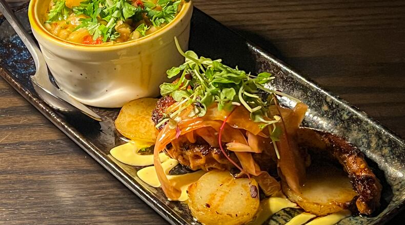 Pulpo parrilla, or grilled octopus, is served with a side of excellent white beans at Silla del Toro's new location in the Toco Hill shopping center. Henri Hollis/henri.hollis@ajc.com