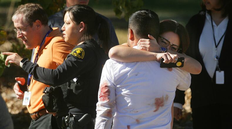 A couple embraces following a shooting that killed multiple people at a social services facility, Wednesday, Dec. 2, 2015, in San Bernardino, Calif. (David Bauman/The Press-Enterprise via AP)