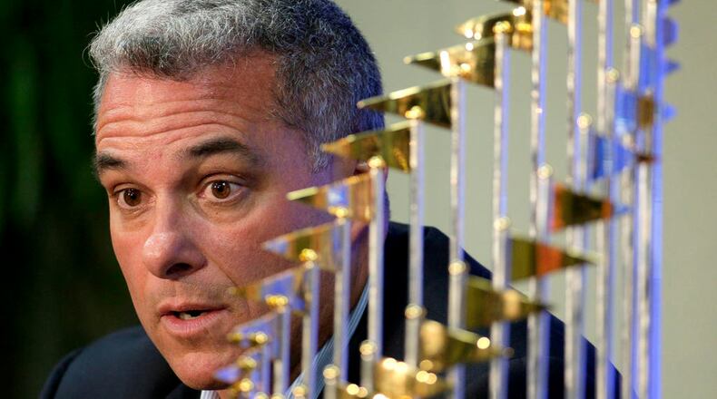 FILE - IN this Nov. 5, 2015, file photo, Kansas City Royals general manager Dayton Moore speaks to members of the media along side the Royals' World Series trophy during a news conference wrapping up the team's season, in Kansas City, Mo. The Royals have signed general manager Dayton Moore and manager Ned Yost to contract extensions, ensuring that the leadership of the World Series champions will remain intact. (AP Photo/Charlie Riedel, File)