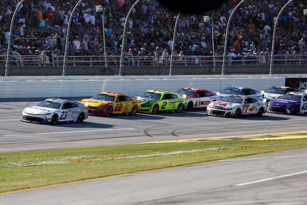 Bubba Wallace (23) leads the pack to win Stage 2 during a NASCAR Cup Series auto race at Talladega Superspeedway, Sunday, April 27, 2025, in Talladega, Ala. (AP Photo/Butch Dill)