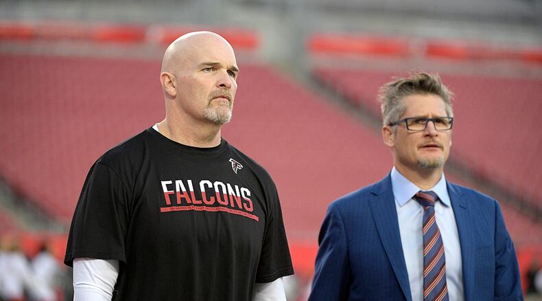 Atlanta Falcons head coach Dan Quinn (left), and general manager Thomas Dimitroff walk on the field before the game against the Tampa Bay Buccaneers Monday, Dec. 18, 2017, in Tampa, Fla.