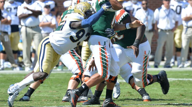 Miami Hurricanes quarterback Brad Kaaya (15) can’t get this pass off as Georgia Tech defensive lineman Antonio Simmons (93) brings him down in the second half at Bobby Dodd Stadium on Saturday, October 1, 2016. Miami won 35-21 over the Yellow Jackets. HYOSUB SHIN / HSHIN@AJC.COM