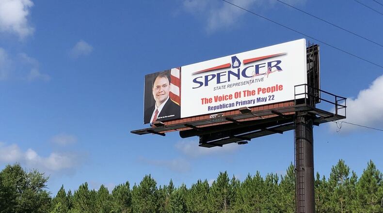 Jason Spencer’s campaign sign still stands in his district. After initially declining calls to step down, he’s announced he’ll leave office. AJC photo: Joshua W. Sharpe