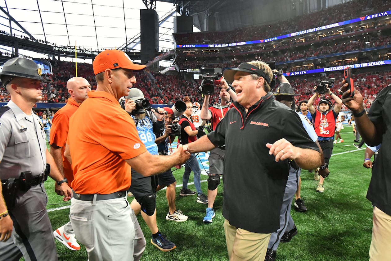 Clemson head coach Dabo Swinney (left) congratulates Georgia head coach Kirby Smart after the Bulldogs beat the Tigers on Saturday, Aug. 31, 2024, in Atlanta. (Hyosub Shin/AJC)