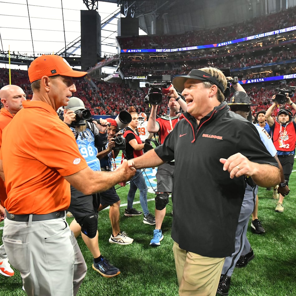 Clemson head coach Dabo Swinney (left) congratulates Georgia head coach Kirby Smart after the Bulldogs beat the Tigers on Saturday, Aug. 31, 2024, in Atlanta. (Hyosub Shin/AJC)