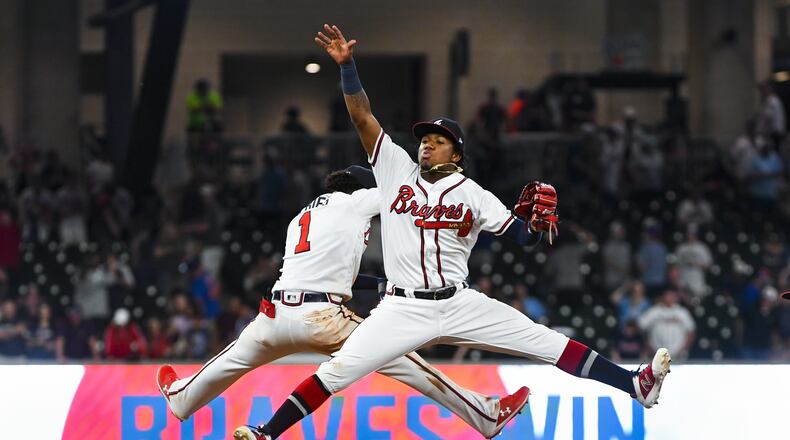 Ronald Acuna Jr. #13 and Ozzie Albies #1 of the Atlanta Braves celebrate an 11-7 win over the New York Mets  at SunTrust Park on April 13, 2019 in Atlanta, Georgia. (Photo by John Amis/Getty Images)