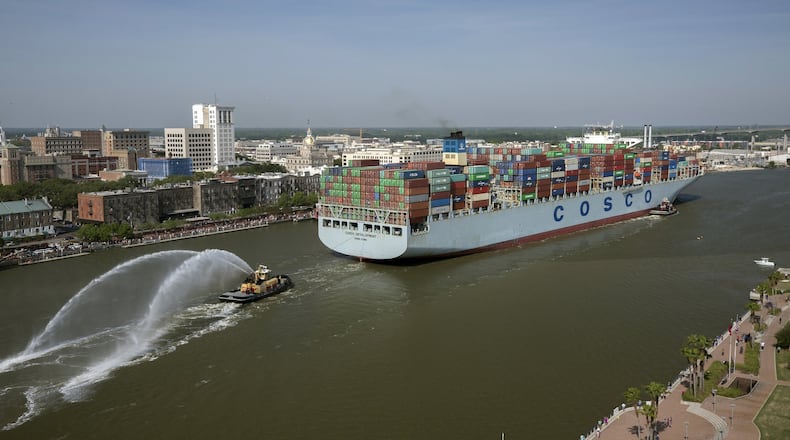 In this photo provided by the Georgia Ports Authority, the container ship COSCO Development sails up river past the historic district of Savannah, Ga., to the Port of Savannah, on Thursday, May 11, 2017. At 1,201 feet long and 158 feet wide, the ship is the largest vessel ever to call on the U.S. East Coast. (AP Photo/Georgia Ports Authority, Stephen Morton)