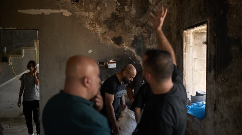 Palestinians gather to repair a damaged house following an attack by Israeli settlers the previous day in the village of Sarra, near the West Bank city of Nablus, Saturday, July 25, 2026. (AP Photo/Leo Correa)
