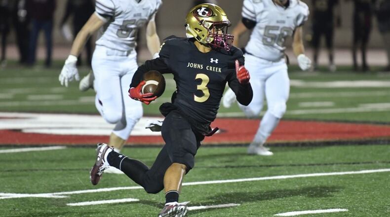 Johns Creek's Yong Min Lee rushes for yardage during Friday's game against Alpharetta. (John Amis/Special)